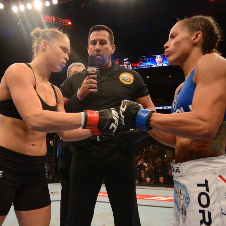 Ronda Rousey (left) and Liz Carmouche (right) touch gloves in their women's bantamweight title fight during UFC 157 at Honda Center on February 23, 2013 in Anaheim, California. (Photo by Donald Miralle/Zuffa LLC/Zuffa LLC via Getty Images)