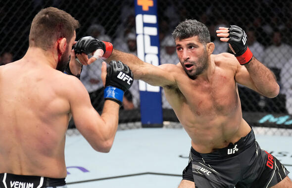 Beneil Dariush of Iran punches Mateusz Gamrot of Poland in a lightweight fight during the UFC 280 event at Etihad Arena on October 22, 2022 in Abu Dhabi, United Arab Emirates. (Photo by Chris Unger/Zuffa LLC)