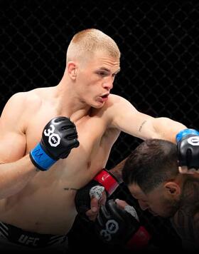 Ian Garry of Ireland punches Daniel Rodriguez in their welterweight fight during the UFC Fight Night event at Spectrum Center on May 13, 2023 in Charlotte, North Carolina. (Photo by Jeff Bottari/Zuffa LLC)