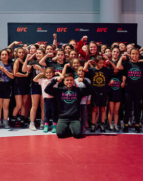 Henry Cejudo poses for photo at UFC and Wrestle Like A Girl's freestyle wrestling clinic on July 6.