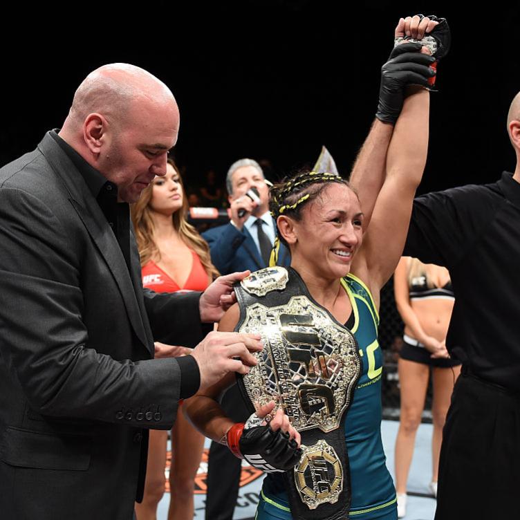 UFC President Dana White presents Carla Esparza with the strawweight championship belt after submitting Rose Namajunas in the third round during The Ultimate Fighter Finale event inside the Pearl concert theater at the Palms Casino Resort on December 12, 2014 in Las Vegas, Nevada. (Photo by Jeff Bottari/Zuffa LLC/Zuffa LLC via Getty Images)