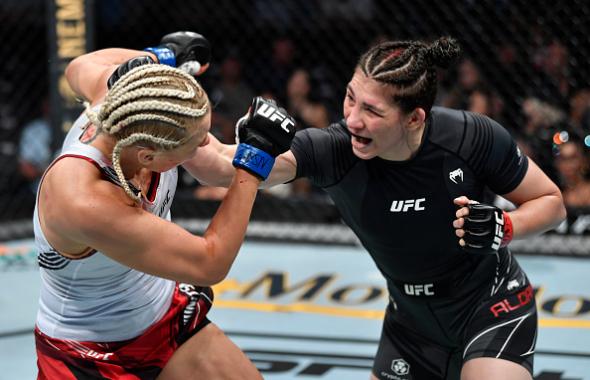 Irene Aldana of Mexico punches Yana Kunitskaya of Russia in their bantamweight fight during the UFC 264 event at T-Mobile Arena on July 10, 2021 in Las Vegas, Nevada. (Photo by Jeff Bottari/Zuffa LLC)