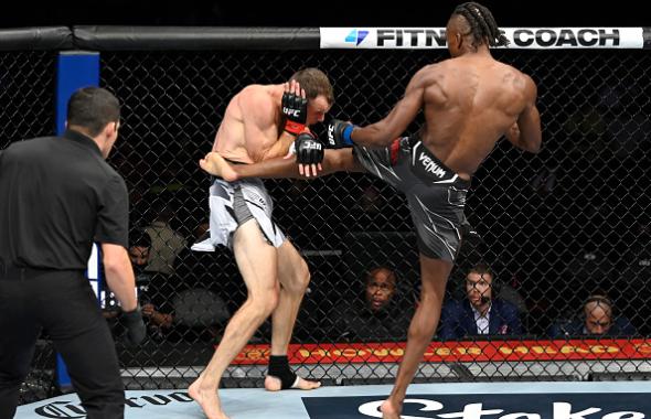 Jalin Turner kicks Uros Medic of Serbia in their lightweight fight during the UFC 266 event on September 25, 2021 in Las Vegas, Nevada. (Photo by Jeff Bottari/Zuffa LLC)