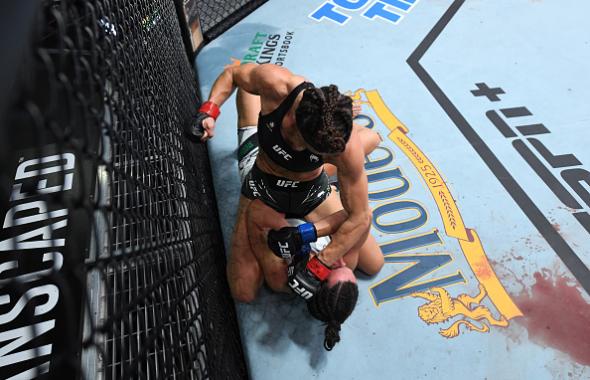 Mackenzie Dern (top) punches Marina Rodriguez of Brazil in their women's strawweight bout during the UFC Fight Night event at UFC APEX on October 09, 2021 in Las Vegas, Nevada. (Photo by Josh Hedges/Zuffa LLC)