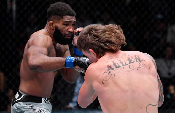 Chris Curtis punches Brendan Allen in their middleweight fight during the UFC Fight Night event at UFC APEX on December 04, 2021 in Las Vegas, Nevada. (Photo by Jeff Bottari/Zuffa LLC)