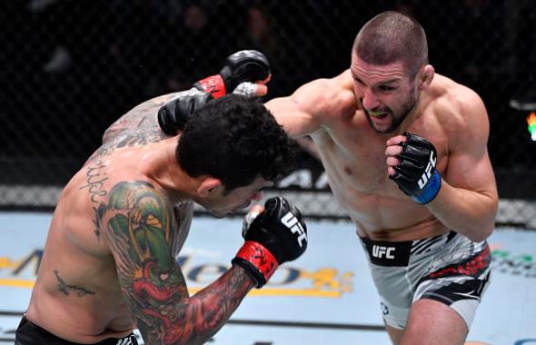 Mateusz Gamrot of Poland punches Diego Ferreira of Brazil in their lightweight fight during the UFC Fight Night event at UFC APEX on December 18, 2021 in Las Vegas, Nevada. (Photo by Jeff Bottari/Zuffa LLC)