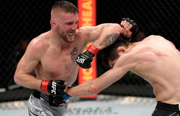 Tim Elliott elbows Tagir Ulanbekov of Russia in their flyweight fight during the UFC 272 event on March 05, 2022 in Las Vegas, Nevada. (Photo by Jeff Bottari/Zuffa LLC)