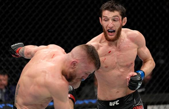 Tagir Ulanbekov of Russia punches Tim Elliott in their flyweight fight during the UFC 272 event on March 05, 2022 in Las Vegas, Nevada. (Photo by Jeff Bottari/Zuffa LLC)