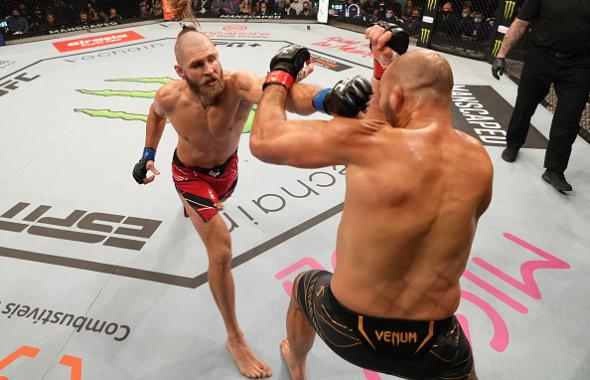 Jiri Prochazka of Czech Republic punches Glover Teixeira of Brazil in the UFC light heavyweight championship fight during the UFC 275 event at Singapore Indoor Stadium on June 12, 2022 in Singapore. (Photo by Jeff Bottari/Zuffa LLC)