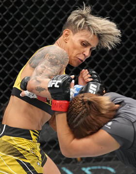 Amanda Lemos of Brazil punches Michelle Waterson-Gomez in a strawweight fight during the UFC Fight Night event at UBS Arena on July 16, 2022 in Elmont, New York. (Photo by Jeff Bottari/Zuffa LLC)