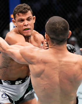 Caio Borralho of Brazil punches Makhmud Muradov of Tajikistan in a middleweight fight during the UFC 280 event at Etihad Arena on October 22, 2022 in Abu Dhabi, United Arab Emirates. (Photo by Chris Unger/Zuffa LLC)