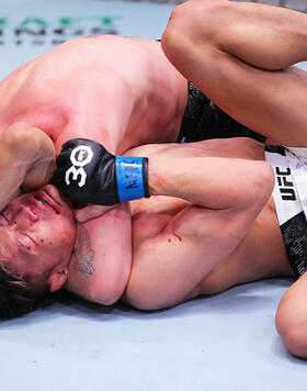 Tim Elliott secures a choke submission against Sumudaerji of China in a bantamweight fight during the UFC Fight Night event at UFC APEX on December 09, 2023 in Las Vegas, Nevada. (Photo by Jeff Bottari/Zuffa LLC)