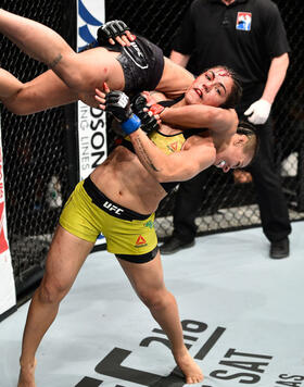 SAITAMA, JAPAN - SEPTEMBER 22:  (R-L) Jessica Andrade of Brazil takes down Claudia Gadelha of Brazil in their women's strawweight bout during the UFC Fight Night event inside the Saitama Super Arena on September 22, 2017 in Saitama, Japan. (Photo by Jeff 