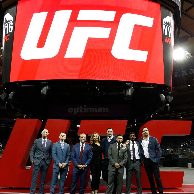 UFC CEO Lorenzo Fertitta (3rd, L) is joined by UFC fighters Ryan LaFlare, Chris Wade, Ronda Rousey, Gian Villante, Dennis Bermudez, Aljamain Sterling and Chris Weidman prior to a bill signing to legalize Mixed Martial Arts fighting in New York State at Madison Square Garden on April 14, 2016 in New York City. (Photo by Jeff Zelevansky/Zuffa LLC)